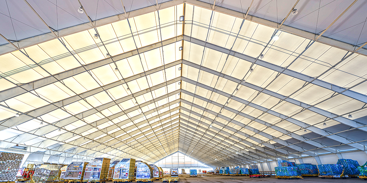 Durable tension fabric pavilion riding arenas for year-round use
