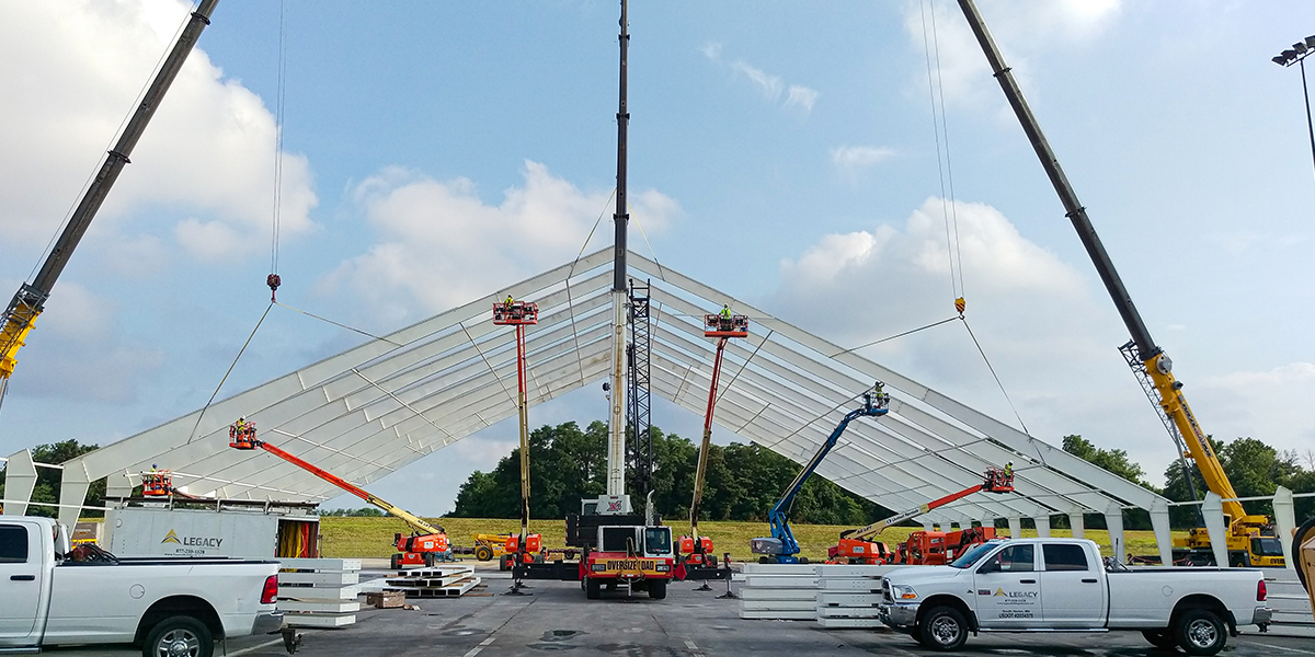 Rigid steel frame installation for tension fabric building
